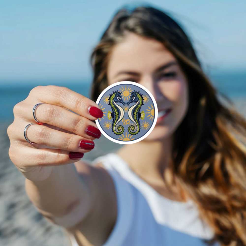 A beautiful young woman holding a seahorse sticker